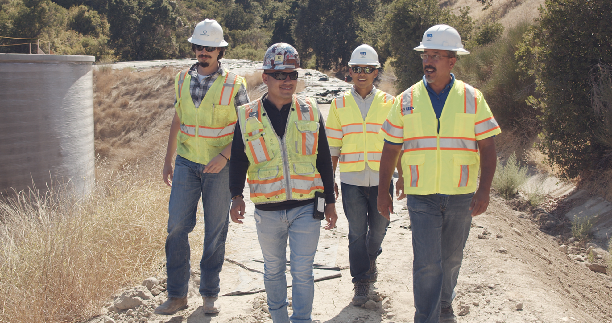 Four San Jose Water engineers walking through an outdoor facility