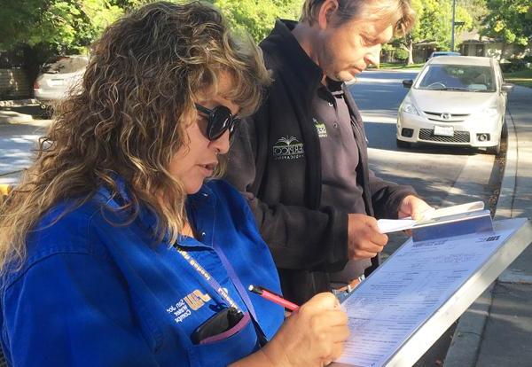 SJW employees jotting down notes on the field